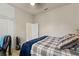 Bedroom with a neutral color scheme, ceiling fan and a plaid comforter at 9245 Grand Cypress Dr, Spring Hill, FL 34613