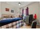 Cozy bedroom with a plaid comforter, dark wood floors, and a ceiling fan at 9245 Grand Cypress Dr, Spring Hill, FL 34613