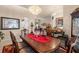 Formal dining room features a decorative chandelier, wood furniture, and view to living room at 9245 Grand Cypress Dr, Spring Hill, FL 34613