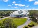 View of a stately home and curved driveway from an aerial perspective at 9245 Grand Cypress Dr, Spring Hill, FL 34613
