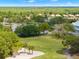 Enjoy this serene golf course view, featuring lush greenery, a sand trap, and palm trees creating a peaceful outdoor space at 9245 Grand Cypress Dr, Spring Hill, FL 34613