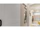 Hallway leading to bathroom with a stand-alone tub and white cabinets at 9245 Grand Cypress Dr, Spring Hill, FL 34613