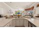 Open kitchen features white cabinets, expansive countertops, and seamless flow into the adjacent living area at 9245 Grand Cypress Dr, Spring Hill, FL 34613