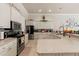 Bright kitchen features tile floors, stainless steel appliances, and white cabinets at 9245 Grand Cypress Dr, Spring Hill, FL 34613