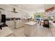 Spacious kitchen featuring white cabinets, granite countertops, and a large island, ideal for cooking and entertaining at 9245 Grand Cypress Dr, Spring Hill, FL 34613