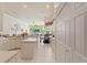Well-lit kitchen with island, granite countertops, and view of living area at 9245 Grand Cypress Dr, Spring Hill, FL 34613