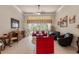 Bright living room with tile floors and red furniture at 9245 Grand Cypress Dr, Spring Hill, FL 34613