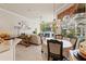 Open-concept living room with dining area, fireplace, and views of the pool at 9245 Grand Cypress Dr, Spring Hill, FL 34613