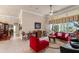 Bright and airy living room with comfortable seating, tile floors, and large windows at 9245 Grand Cypress Dr, Spring Hill, FL 34613