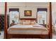 Beautifully furnished bedroom with four-poster bed and matching lamps at 9245 Grand Cypress Dr, Spring Hill, FL 34613