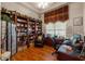 Well-lit office featuring a large bookcase and wood flooring at 9245 Grand Cypress Dr, Spring Hill, FL 34613