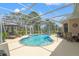 Beautiful pool area with a screen enclosure, creating a private outdoor space at 9245 Grand Cypress Dr, Spring Hill, FL 34613