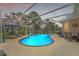 Screened-in pool with lighting offers a relaxing outdoor space for leisure and entertaining at 9245 Grand Cypress Dr, Spring Hill, FL 34613
