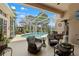 Relaxing screened-in pool area with comfortable seating and beautiful landscaping at 9245 Grand Cypress Dr, Spring Hill, FL 34613