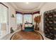 Sitting area features a couch, decorative rug, and large windows with natural light at 9245 Grand Cypress Dr, Spring Hill, FL 34613