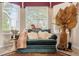 Close up view of the comfortable sitting area with a green chaise lounge, cheetah print throw and pillows at 9245 Grand Cypress Dr, Spring Hill, FL 34613