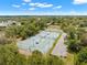 Overhead shot of community tennis courts surrounded by lush trees, creating a private and active recreational area at 9245 Grand Cypress Dr, Spring Hill, FL 34613