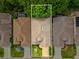 Aerial view of a well-maintained home with a manicured lawn and a neutral-toned roof, surrounded by lush greenery at 10187 Holly Berry Dr, Weeki Wachee, FL 34613