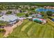 Aerial view of the community clubhouse, pool, and tennis courts, showcasing the recreational amenities at 10187 Holly Berry Dr, Weeki Wachee, FL 34613