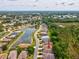 Beautiful aerial view of homes along a lakefront, showcasing a desirable community with scenic water views at 10187 Holly Berry Dr, Weeki Wachee, FL 34613