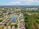 Picturesque aerial view of a neighborhood nestled by a serene lake, highlighting the community's attractive location at 10187 Holly Berry Dr, Weeki Wachee, FL 34613