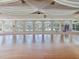 Spacious banquet hall with wood floors and large windows at 10187 Holly Berry Dr, Weeki Wachee, FL 34613