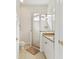 A well-lit bathroom with a glass shower and a granite countertop vanity at 10187 Holly Berry Dr, Weeki Wachee, FL 34613