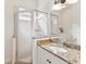 Bathroom featuring a glass shower and granite countertop vanity with great lighting at 10187 Holly Berry Dr, Weeki Wachee, FL 34613