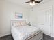 This bedroom features a full bed, a nightstand, a ceiling fan, and a closet at 10187 Holly Berry Dr, Weeki Wachee, FL 34613