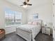 This bedroom features a full bed, a nightstand, a window, and a ceiling fan at 10187 Holly Berry Dr, Weeki Wachee, FL 34613