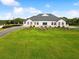 Elegant clubhouse exterior featuring classic architecture, lush lawns, and a welcoming driveway at 10187 Holly Berry Dr, Weeki Wachee, FL 34613