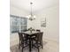 Dining room features a modern chandelier, and a view of the outdoors at 10187 Holly Berry Dr, Weeki Wachee, FL 34613