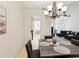 Open-concept dining area with tiled floors, chandelier, and easy access to the kitchen at 10187 Holly Berry Dr, Weeki Wachee, FL 34613