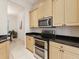 Modern kitchen with stainless steel appliances, a double oven and light wood cabinets at 10187 Holly Berry Dr, Weeki Wachee, FL 34613