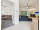 Open-concept living area with tile flooring, ceiling fan, and a seamless flow to the dining space at 10187 Holly Berry Dr, Weeki Wachee, FL 34613