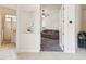 Inviting living room area with neutral walls, transition to the bathroom, and cozy seating arrangement at 10187 Holly Berry Dr, Weeki Wachee, FL 34613