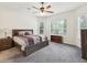 Spacious main bedroom with neutral carpet, ceiling fan, and large windows at 10187 Holly Berry Dr, Weeki Wachee, FL 34613
