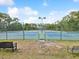 Pickleball courts with a bright blue playing surface, surrounded by fencing, are ready for play at 10187 Holly Berry Dr, Weeki Wachee, FL 34613