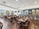 Restaurant area with tables and chairs next to a bar with bottles of liquor and multiple TV screens at 10187 Holly Berry Dr, Weeki Wachee, FL 34613