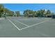 Well-maintained tennis court with a shaded viewing area for players and spectators at 10187 Holly Berry Dr, Weeki Wachee, FL 34613
