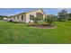 Well-maintained backyard with lush green grass, mature landscaping, and a view of the home's exterior at 1032 Walnut Hill Ct, Spring Hill, FL 34609