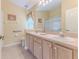 Bathroom with double vanity, tile floor, and decorative elements providing functionality and style at 1032 Walnut Hill Ct, Spring Hill, FL 34609