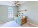 Bright bedroom featuring a comfortable daybed, large window, and charming decorative shelves at 1032 Walnut Hill Ct, Spring Hill, FL 34609