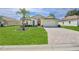 Beautiful single-Gathering home with a lush front lawn and brick-paved driveway at 1032 Walnut Hill Ct, Spring Hill, FL 34609