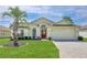 Charming single-story home featuring a well-manicured lawn and inviting red front door at 1032 Walnut Hill Ct, Spring Hill, FL 34609