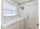 Convenient laundry room with modern washer and dryer units near the backdoor for easy access at 1032 Walnut Hill Ct, Spring Hill, FL 34609