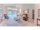 Bright living room with large windows, plush seating, and neutral décor at 1032 Walnut Hill Ct, Spring Hill, FL 34609