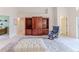 Well-appointed living area with a plush ottoman and a built-in wooden bookcase at 1032 Walnut Hill Ct, Spring Hill, FL 34609