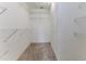 Spacious walk-in closet with wall mounted shelving and beige carpeting providing ample storage solutions at 1032 Walnut Hill Ct, Spring Hill, FL 34609