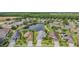 Aerial view of a lush neighborhood with well-maintained lawns and a tranquil lake at 1053 Winding Willow Dr, Trinity, FL 34655